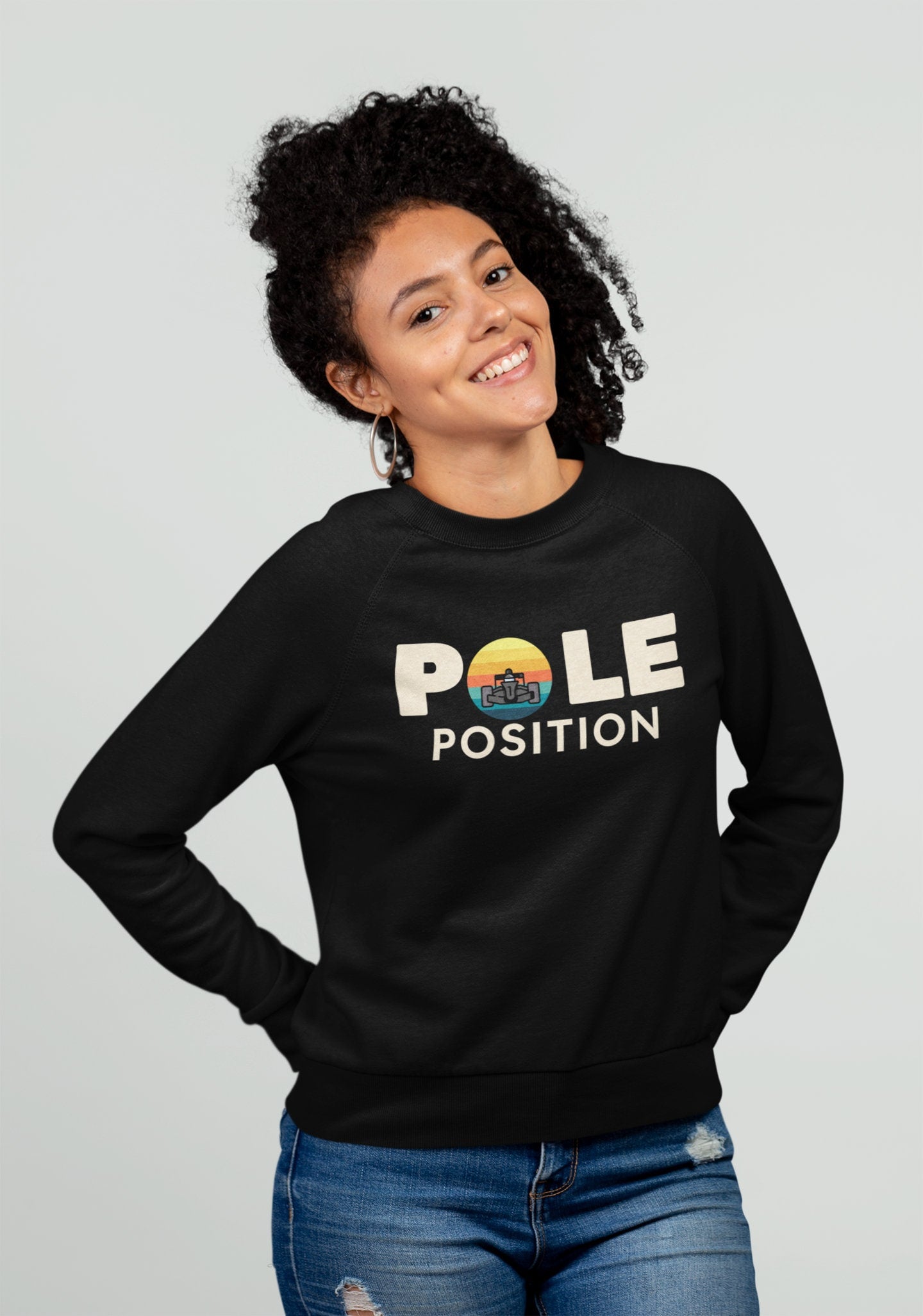 Person wearing a black sweatshirt with 'Pole Position' text on a plain background