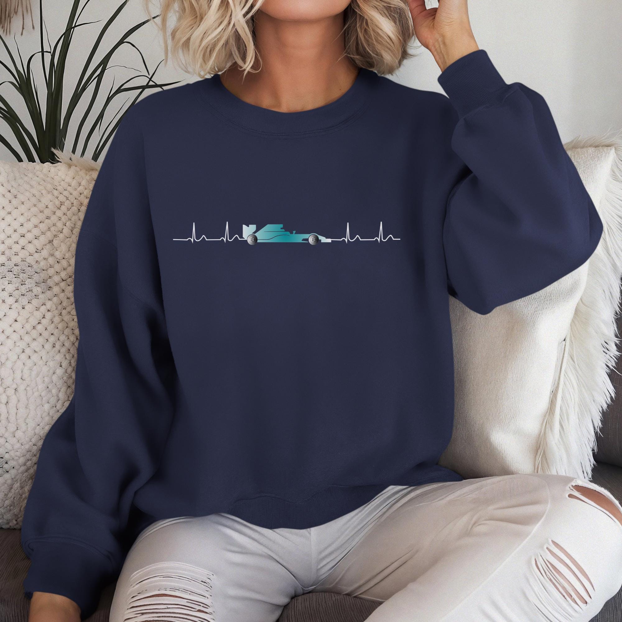 A navy blue sweatshirt with a white graphic of a race car inside a heartbeat. The graphic is centered on the chest of the sweatshirt.