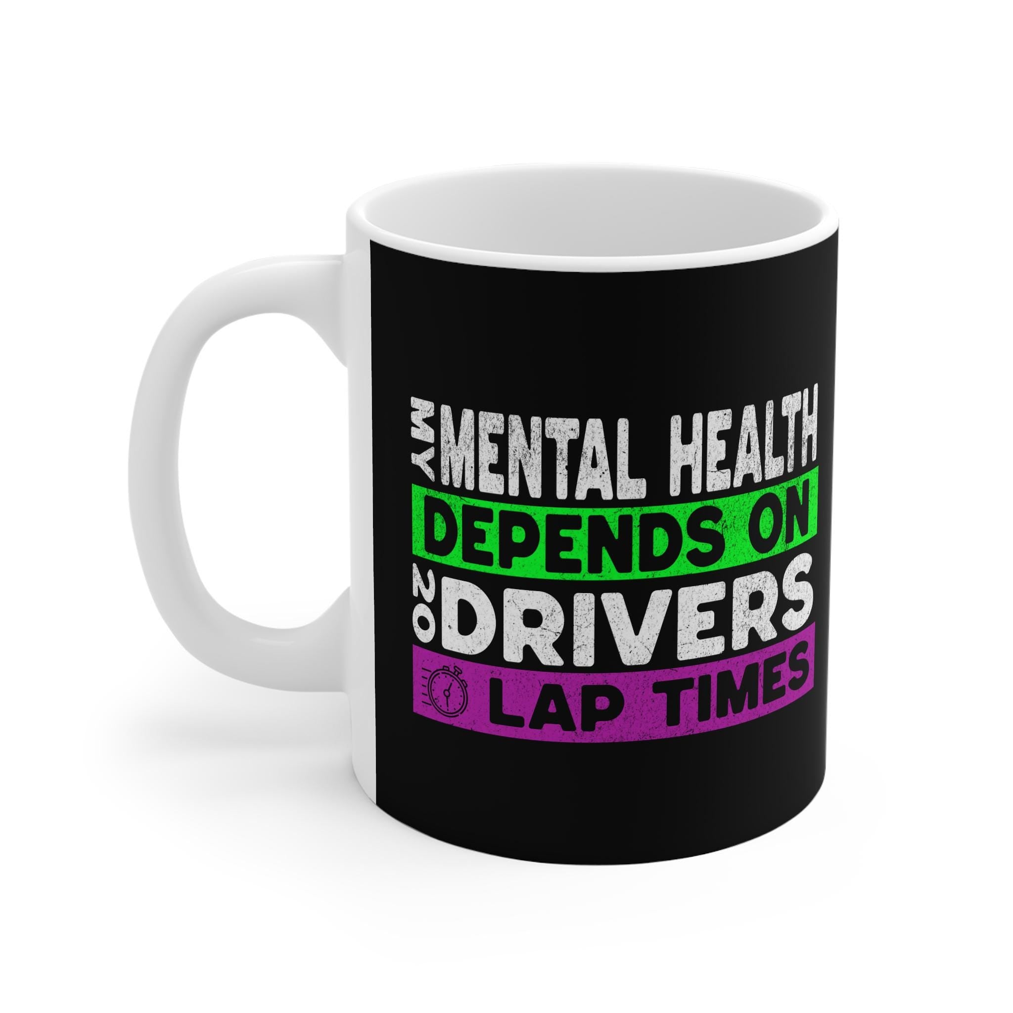 A white coffee mug with a black handle. The mug has a black background with white text that reads &#39;My mental health depends on drivers lap times&#39; in green and purple text. The text is stylized to look like a racing logo.