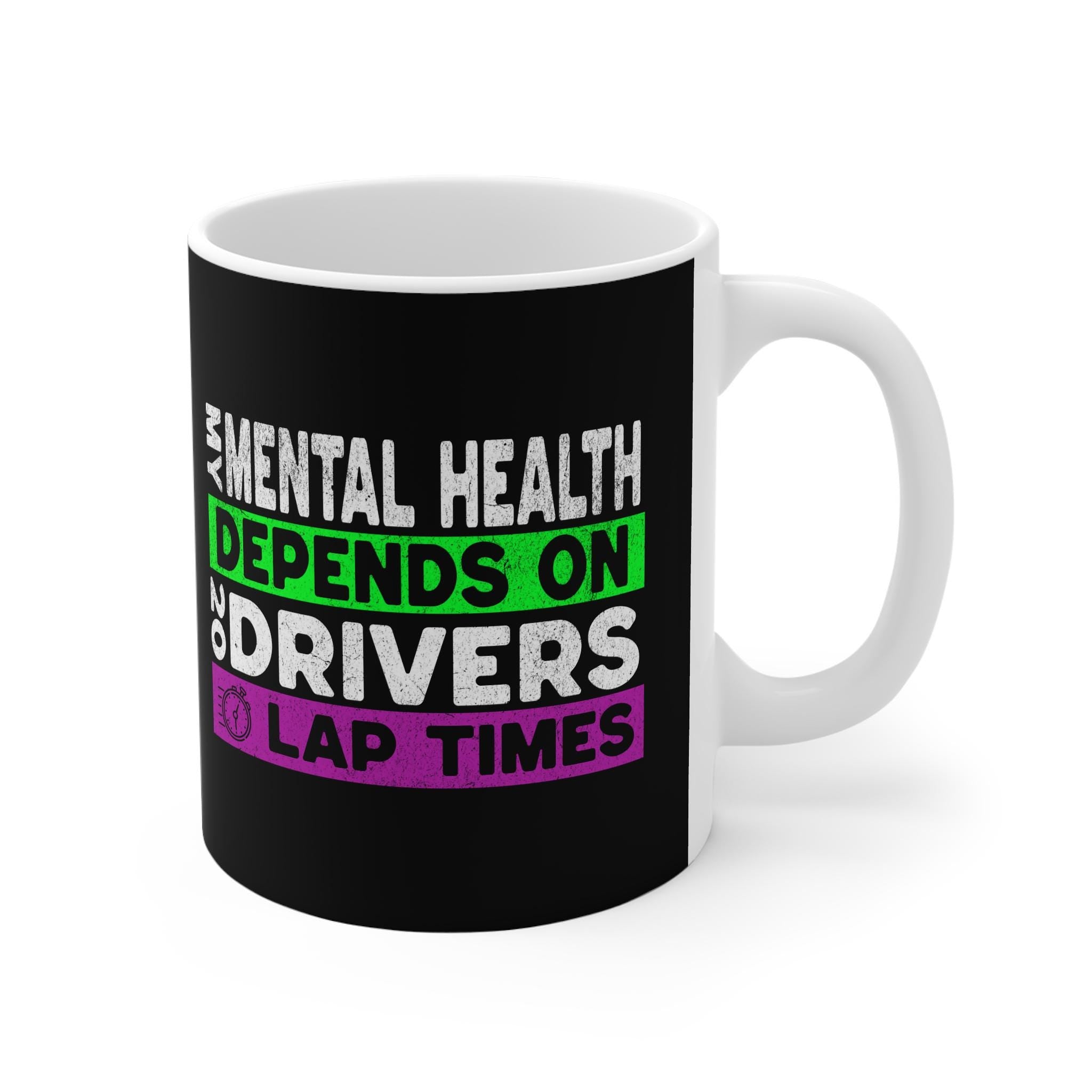 A white coffee mug with a black background and white text that reads &#39;Mental Health Depends On Drivers Lap Times&#39; in green and purple text.